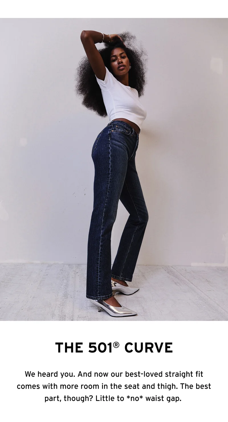 Woman wearing dark wash jeans and a white t-shirt.