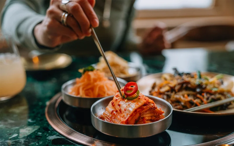 Fermented vegetables like kimchi are thought to bolster your mood by improving your gut microbiome. They do so by populating your gut with healthy bacteria that balance out the bad bacteria.