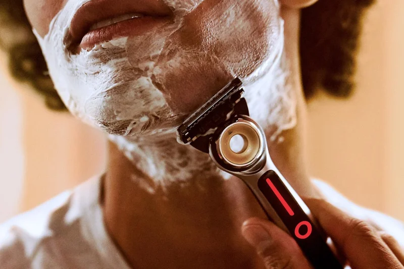 Man shaving his face with GilletteLabs Heated razor