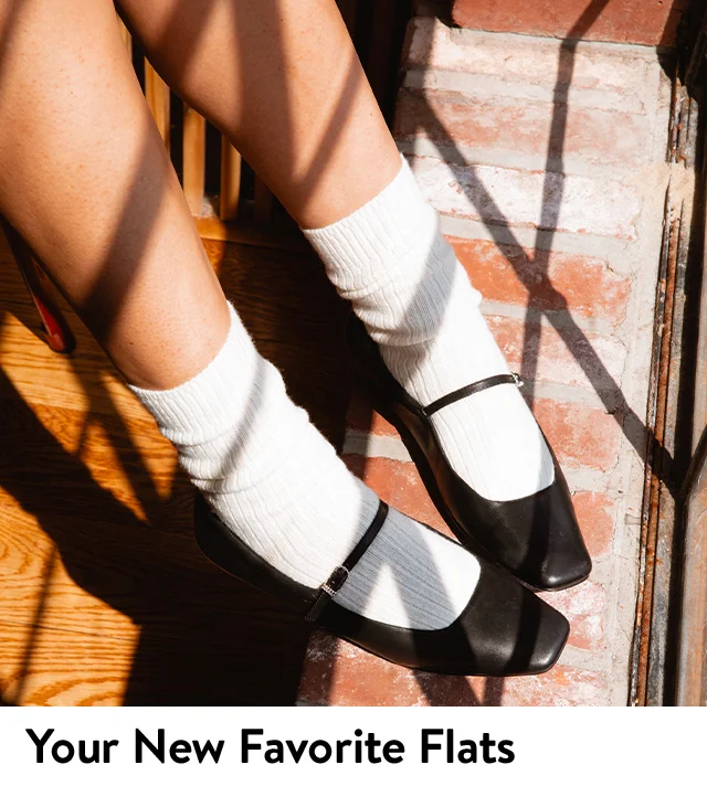 A woman wearing black mary janes with white socks.