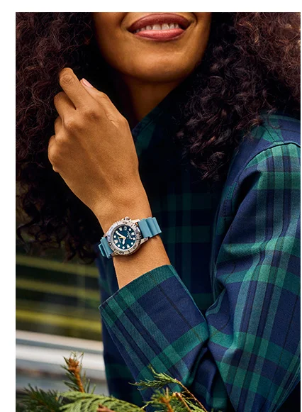 Woman in flannel wearing Promaster Dive