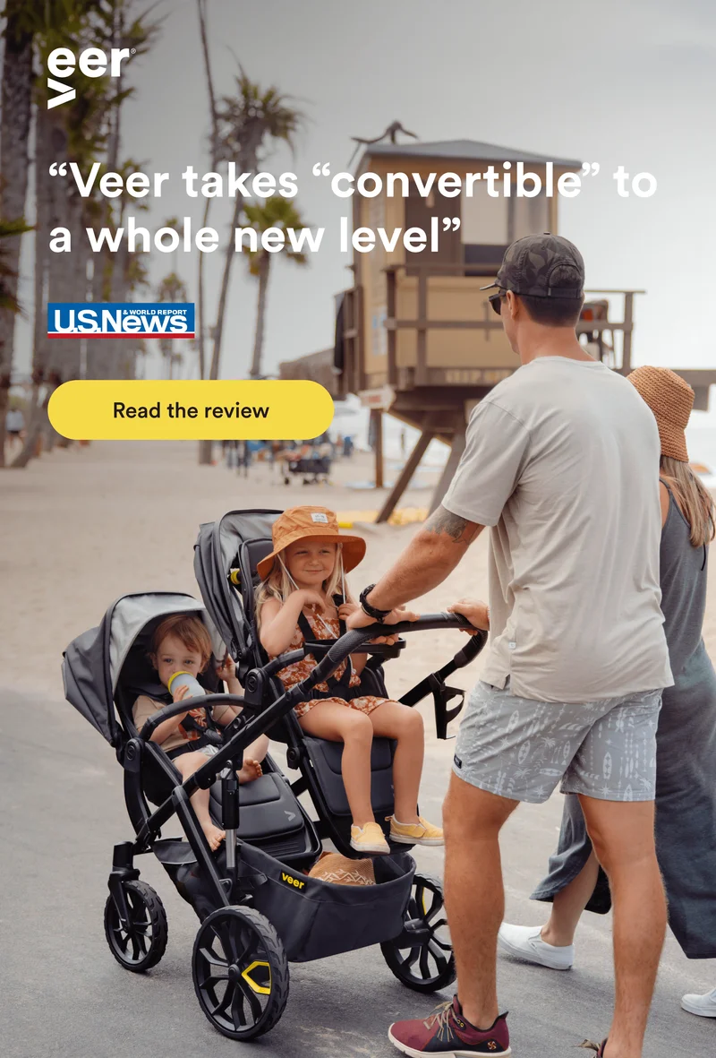 Parents maneuvering the Switch&Roll by the beach.