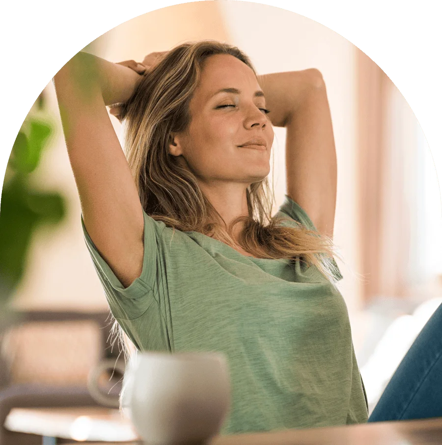 Young woman sitting on edge looks out at view