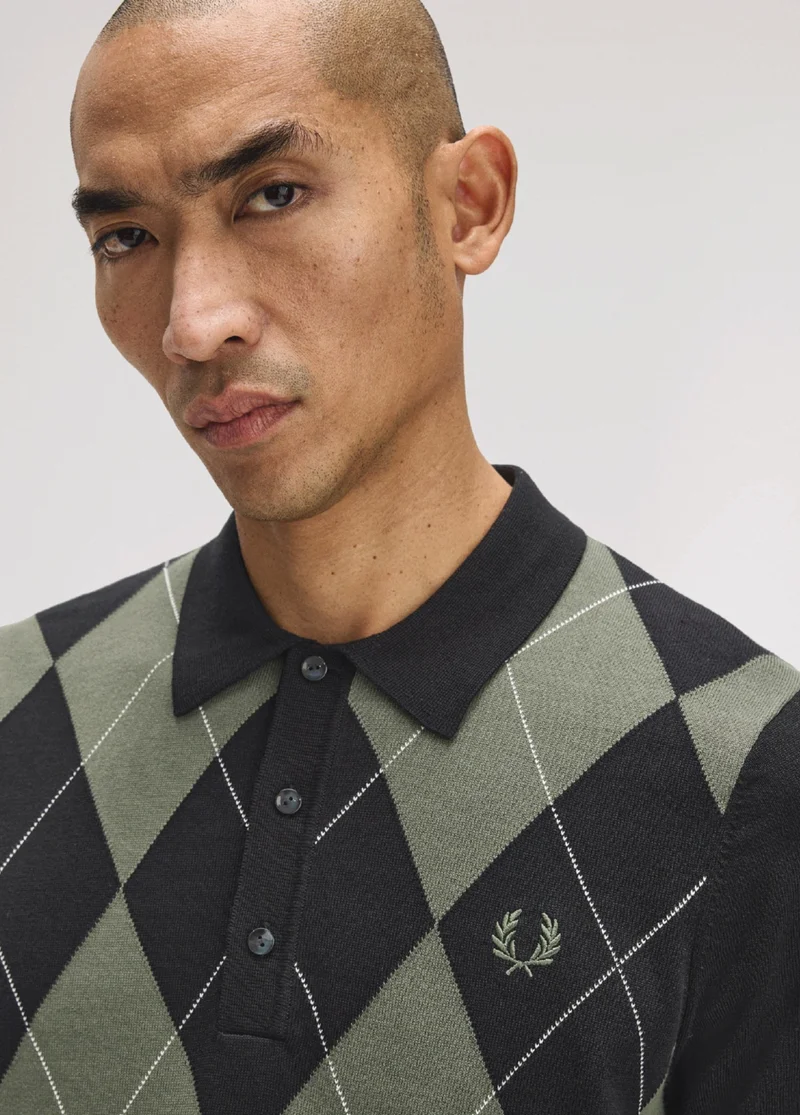 Fred Perry New Releases: model wears a Fred Perry Argyle Knitted Shirt in Black