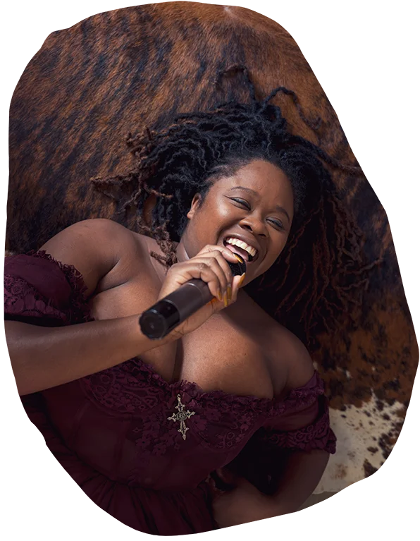 artlist singing into mic on hotel room floor