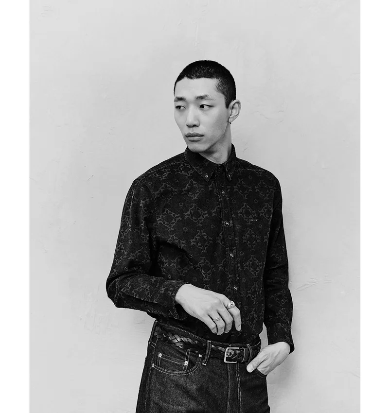 Black and white image of a person wearing a button up