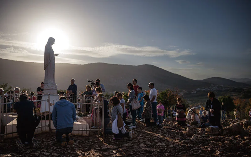 As the sun sets in Medjugorje, Bosnia and Herzegovina—a hot spot for Virgin Mary sightings—devotees of diverse faiths and nationalities gather to pray.