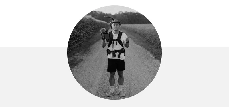Photo of Niles Filmmaker extraordinaire with a camera standing on a road.