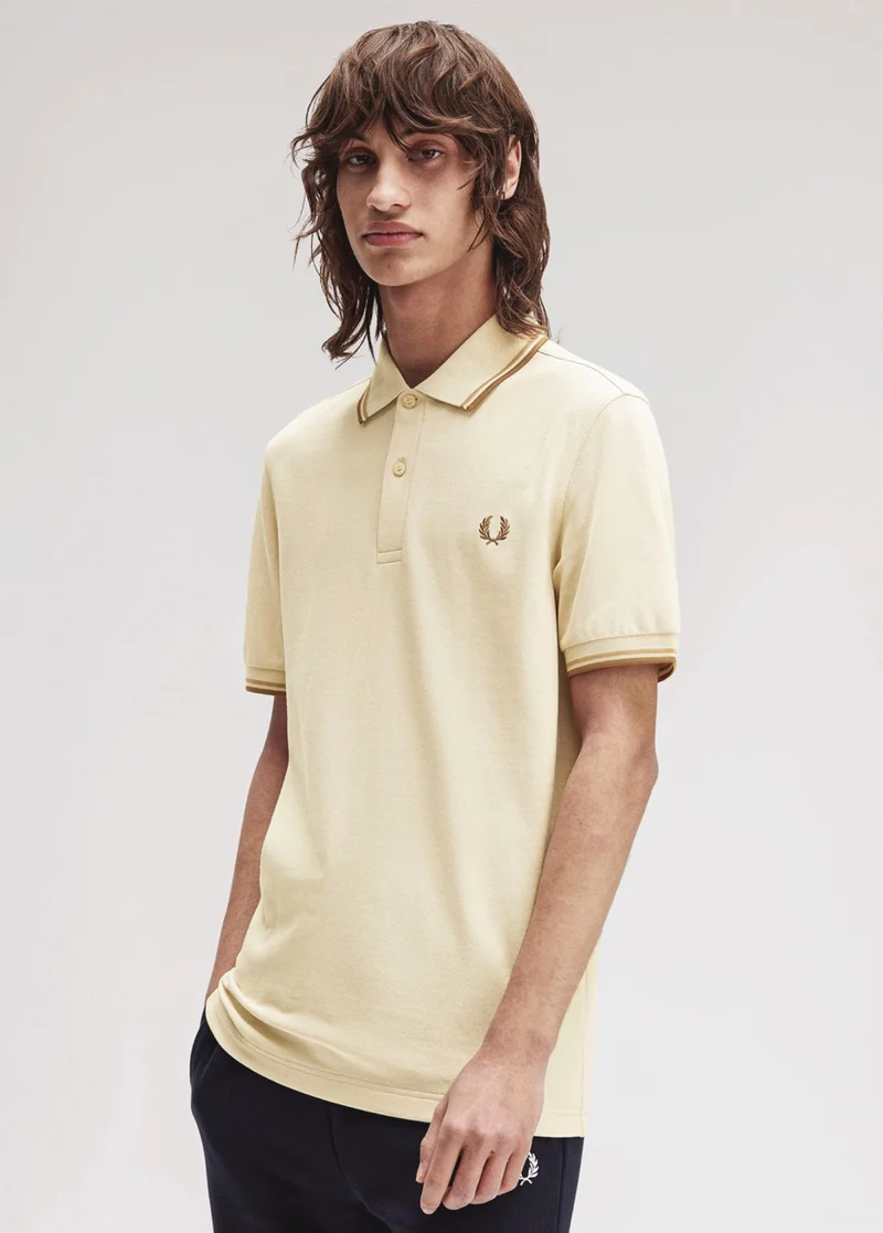 Male model wears a M3600 Fred Perry Shirt in Oatmeal / Warm Stone / Shaded Stone