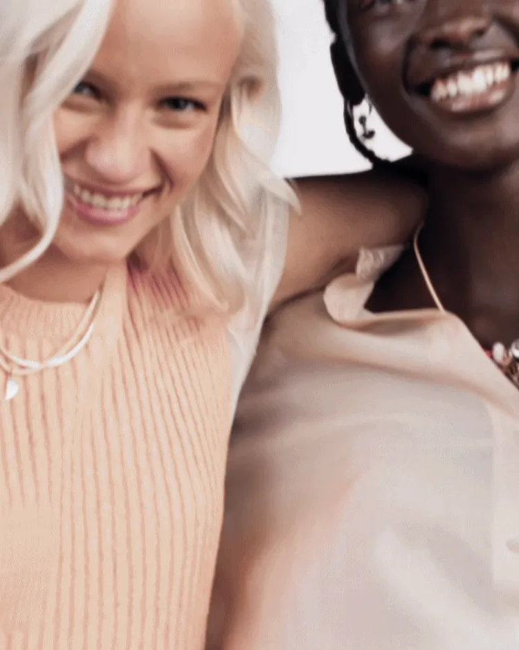 Two friends wearing engraved jewelry