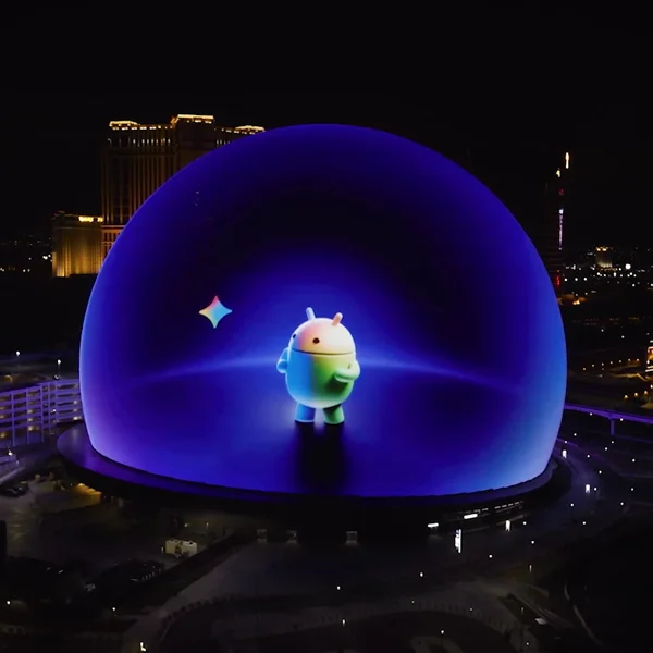 Rainbow Android in blue geodesic dome at night.