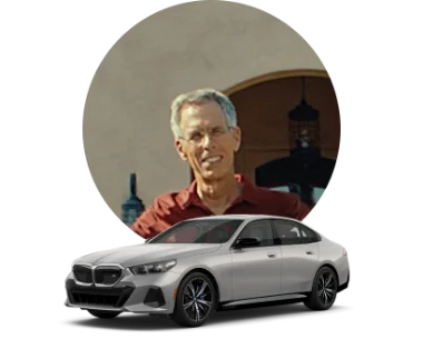 Man's photo adjacent to a silver BMW i5 M60.