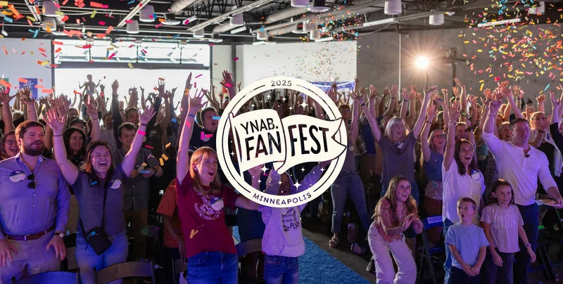 YNABers celebrating during a confetti drop with the Fan Fest Minneapolis logo