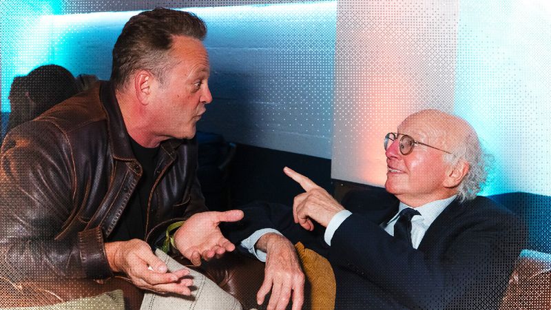 Image may contain: Vince Vaughn, Larry David, Body Part, Finger, Hand, Person, Clothing, Coat, Jacket, and Conversation