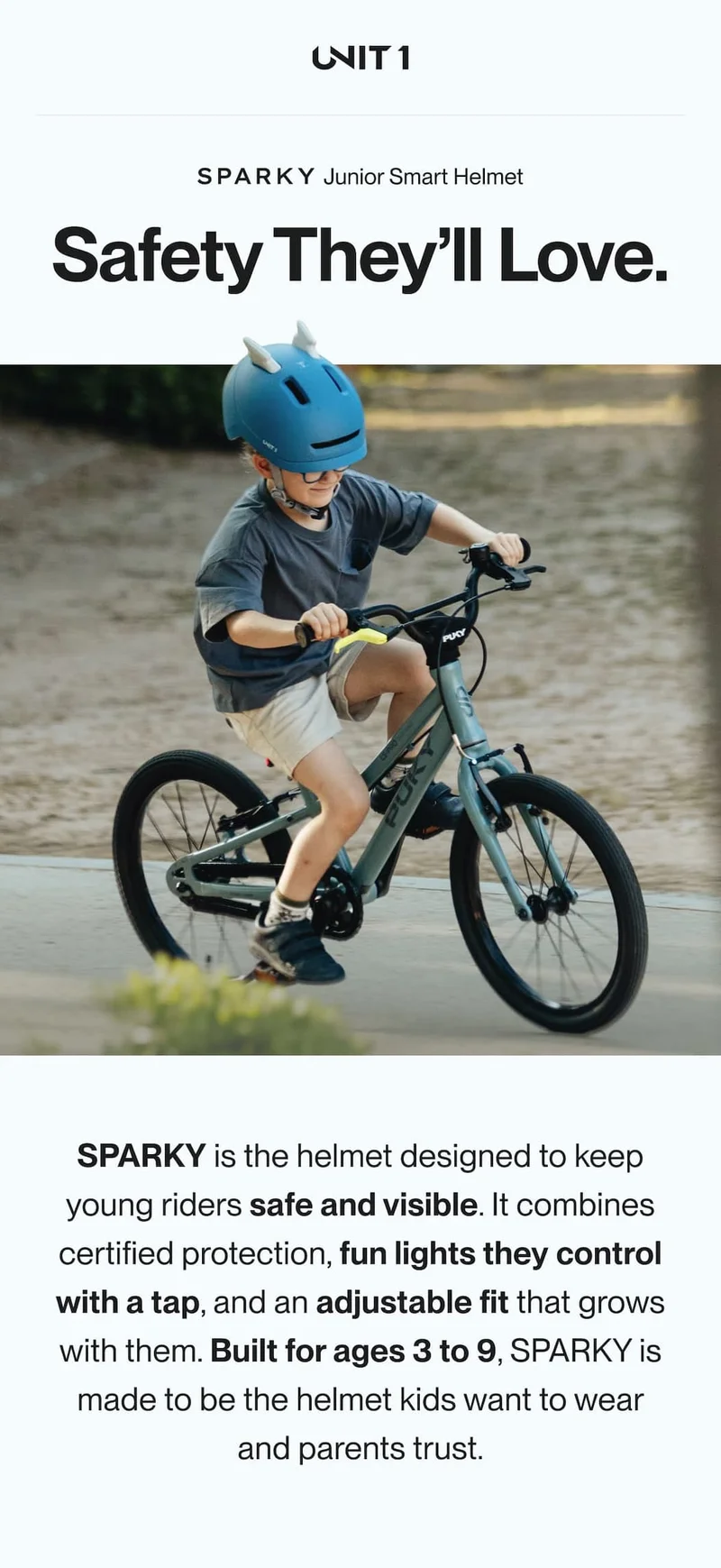 Kid riding a bike wearing the SPARKY Junior Smart Helmet in blue — safety kids love, trusted by parents.
