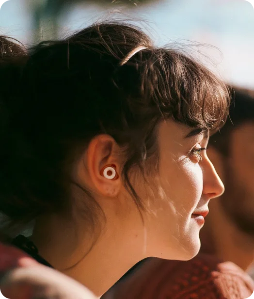Woman wearing Loop Kinetic earplugs
