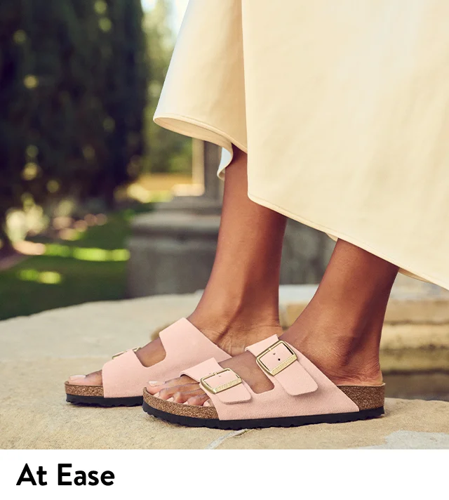 A woman wearing pink Birkenstock sandals.
