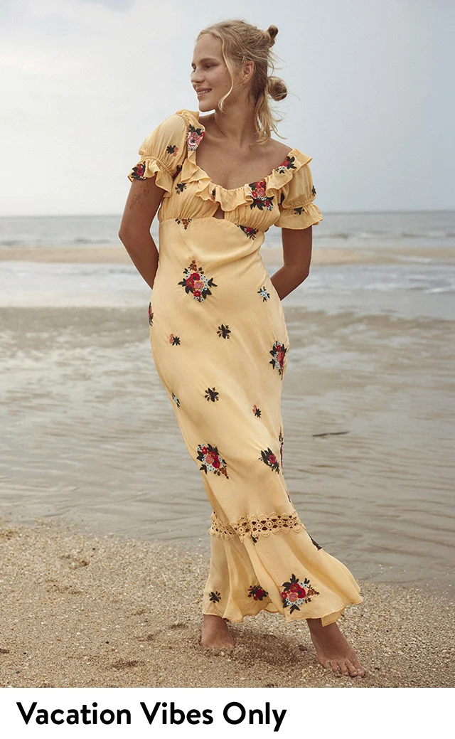 A woman wearing a floral-print maxi dress.