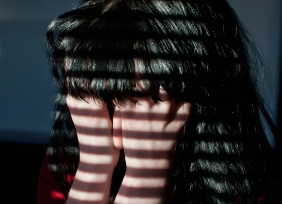 A woman with her face in her hands