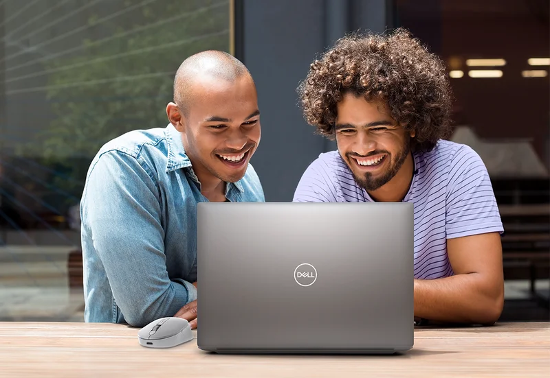 Two friends looking at a laptop