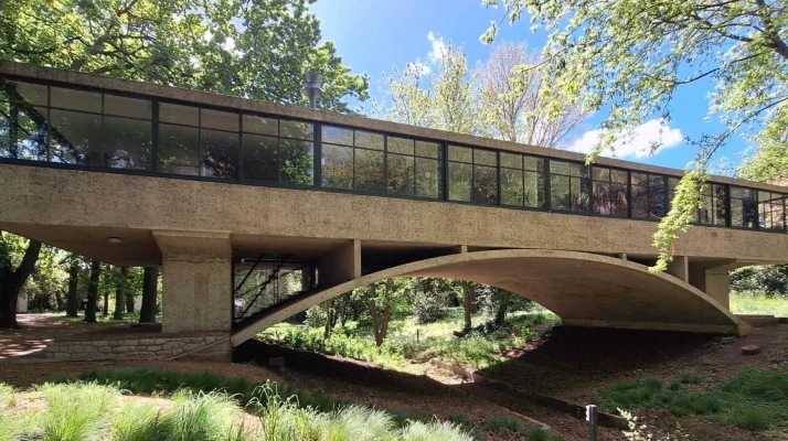 Outside view of Casa sobre el Arroyo in Argentina on a sunny day with trees surrounding.