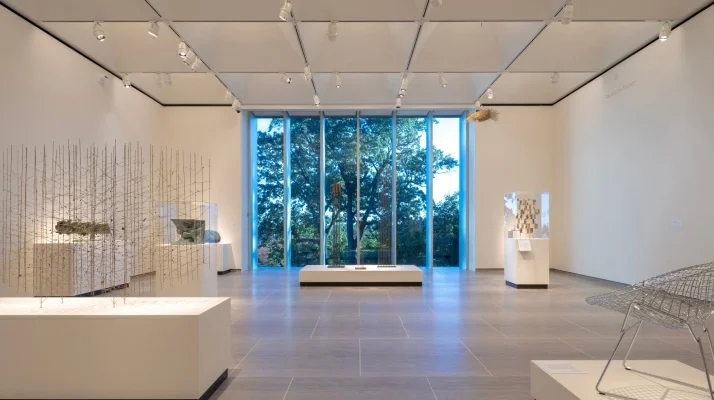 Harry Bertoia: Sculpture for Living exhibit gallery with open, floor-length windows in the background at the Bruce Museum in Greenwich, CT.