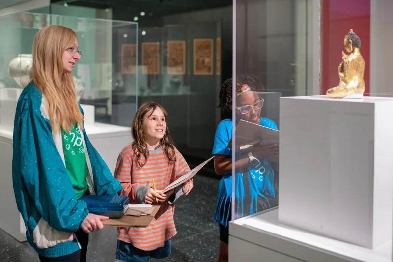 Three young people looking at art