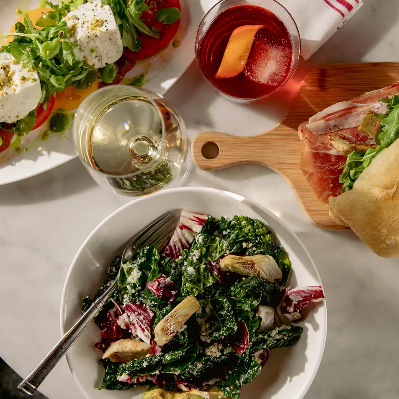 Salad and sandwiches on a table at AperiBar