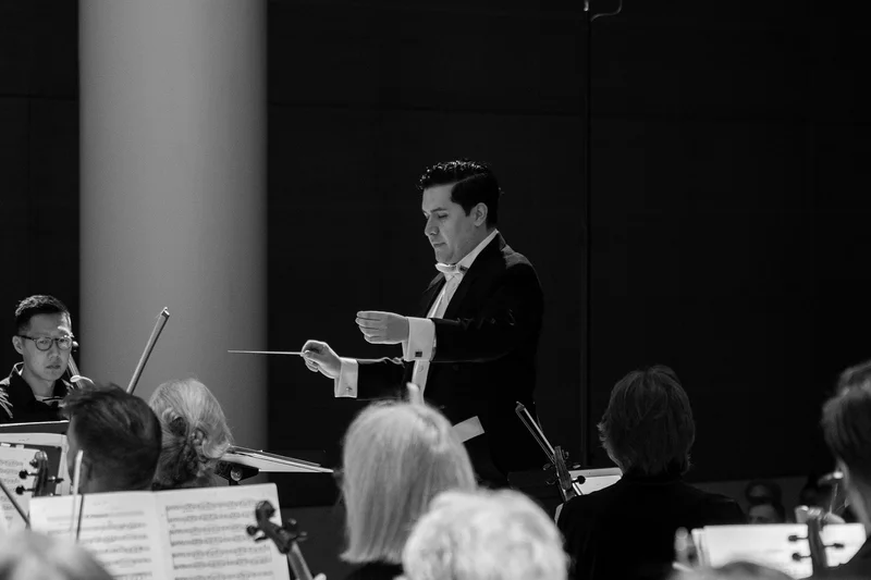 A conductor leading an orchestra
