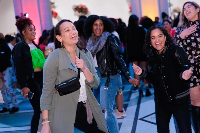A group of people smiling and dancing