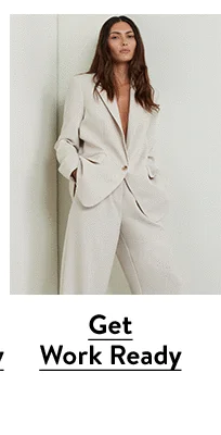 A woman wearing a white blazer with matching pants.