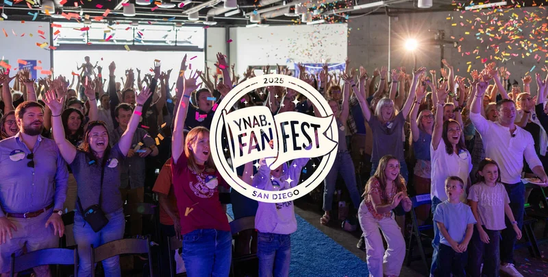 YNABers celebrating during a confetti drop with the Fan Fest San Diego logo