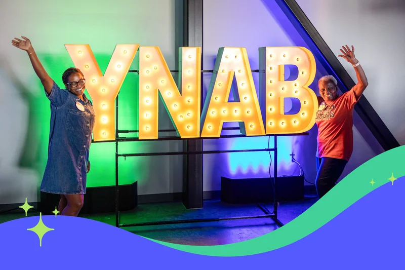 YNABers posing by big 'YNAB' letter lights at Fan Fest