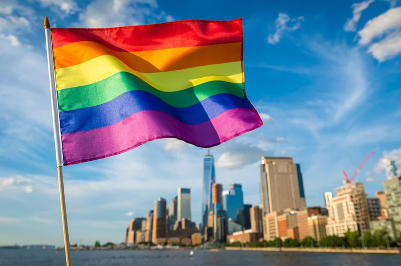 pride rainbow flag with NYC skyline in the background