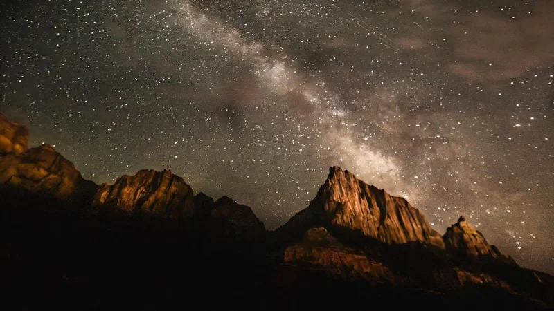 Image description: Milky way above The Watchman rock formation in Zion National Park.