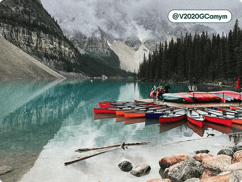 Image description: Colorful canoes lined up on a dock in Banff’s Moraine Lake, photo taken by @V2020GCamym