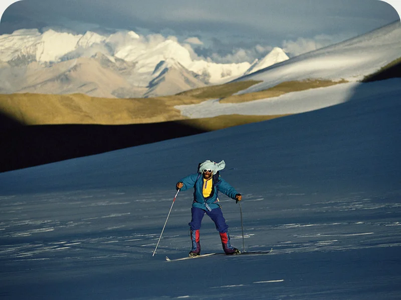 A person skiing through mountains.