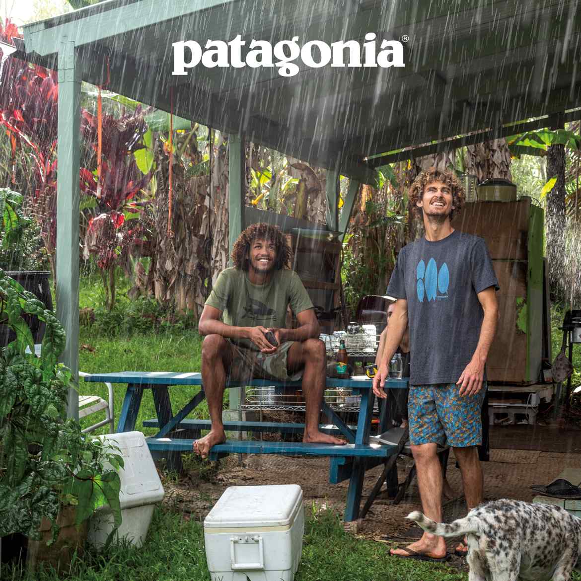 Patagonia. Two people sitting under an awning watching the rain.