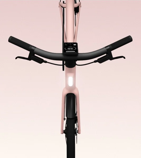 A front-facing view of the Cowboy bike in the Dawn colorway, highlighting the sleek handlebar design, integrated front light, and smart display.
