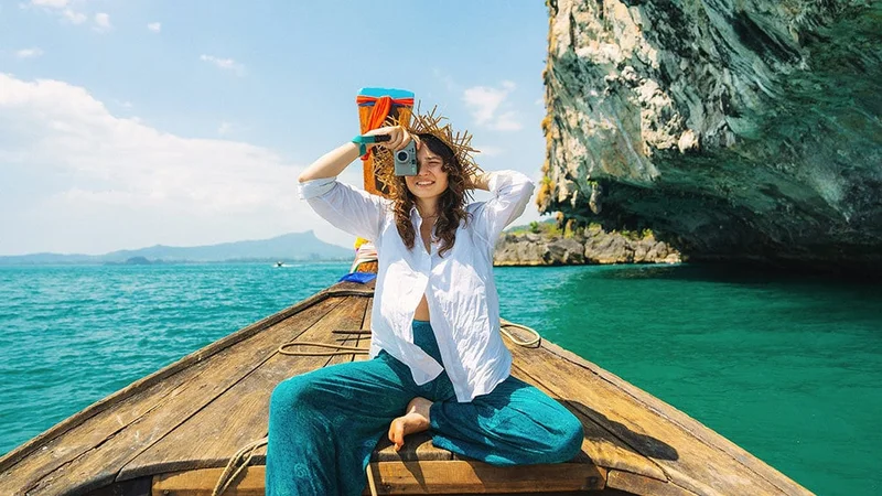 Image description: Woman taking photograph from canoe