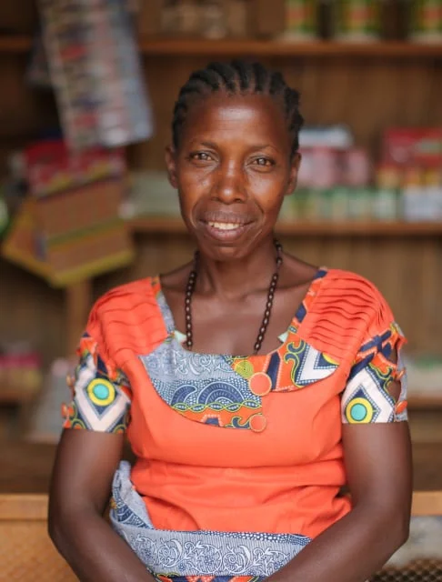 Image description: A woman smiling in a grocery shop.