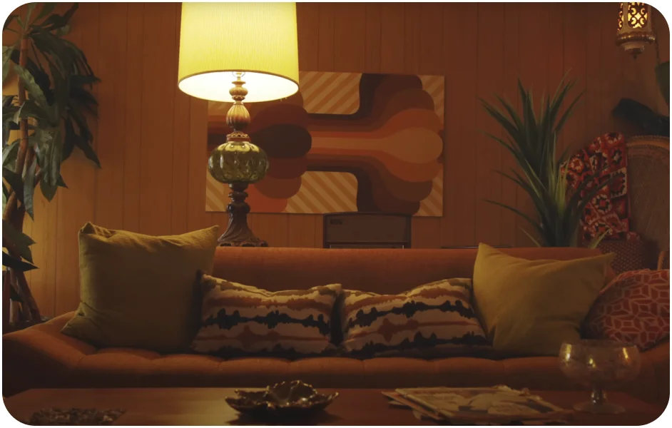 Image of a couch illuminated by a lamp in a warm living room