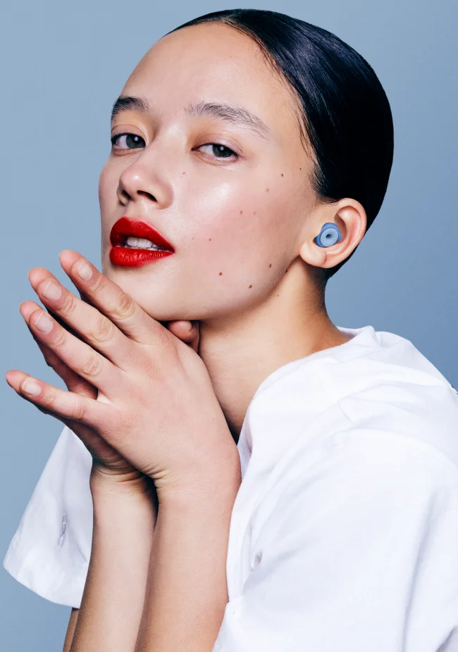 A woman wears a pair of Blue Switch Loops.