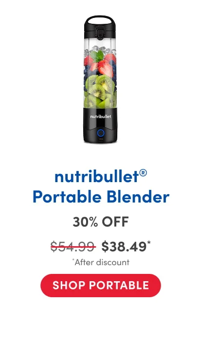 A nutribullet portable blender filled with layers of fresh fruit, including sliced kiwi, blueberries, strawberries, and mint leaves. The blender has a black base with a power button and a carry handle on top.
