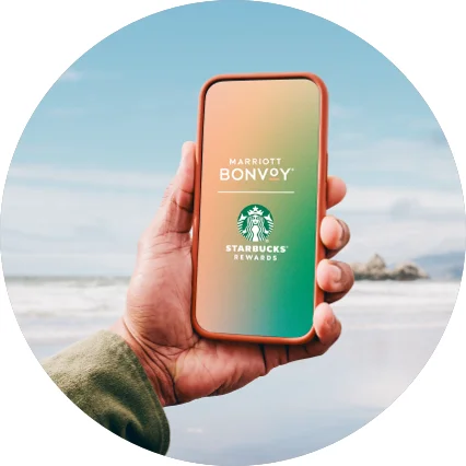 Mobile phone displaying the Marriott Bonvoy and Starbucks logo.