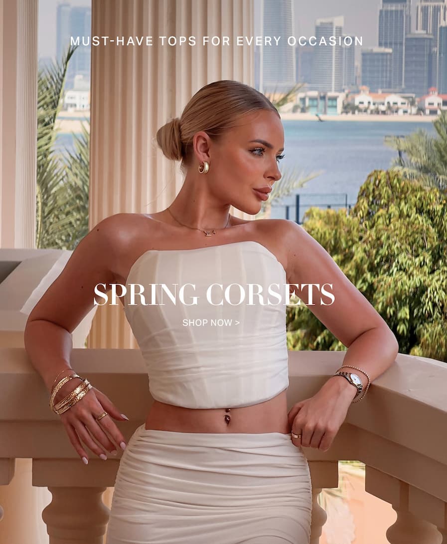 Stylish woman models white strapless spring corset top & ruched skirt. Shop must-have tops for every occasion!