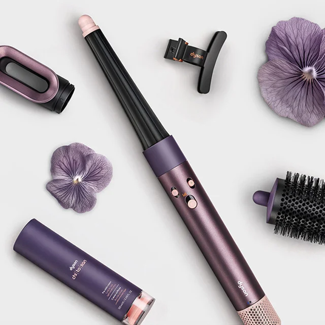The Dyson Airwrap i.d. multi-styler and dryer surrounded by attachments and accessories
