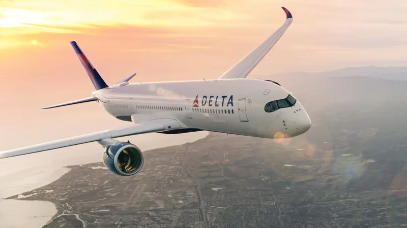 A Delta plane flies over a city