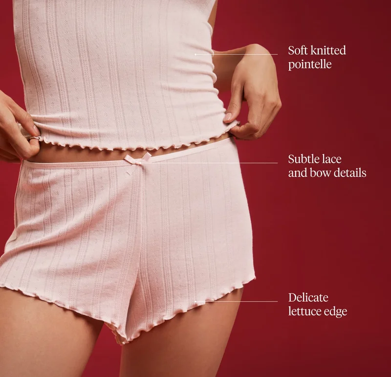 Soft knitted pointelle. Subtle lace and bow details. Delicate lettuce edge.