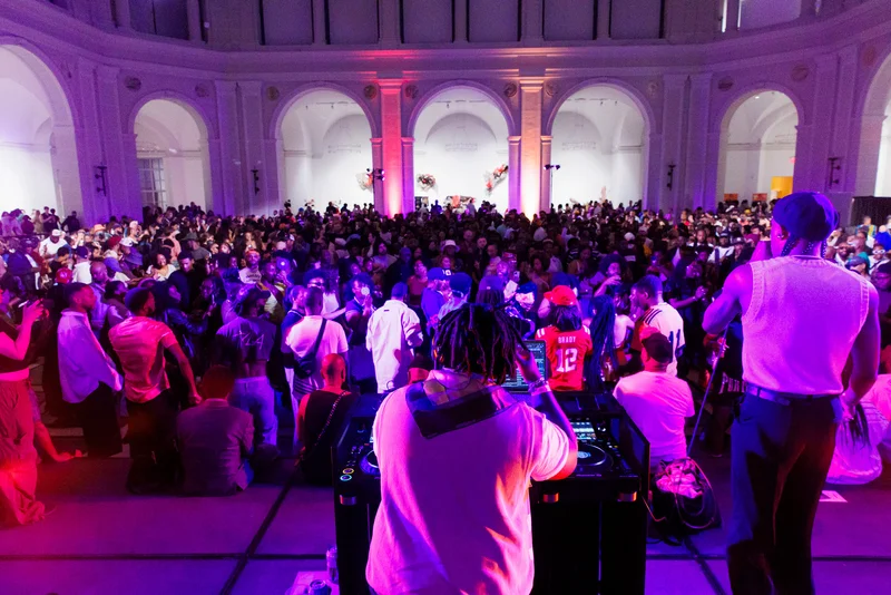 A DJ booth and a dance floor full of people